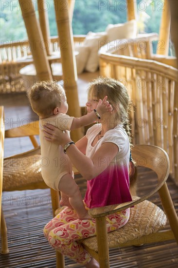 Caucasian girl holding baby boy