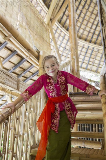 Caucasian girl wearing traditional Hindu clothing on stairs