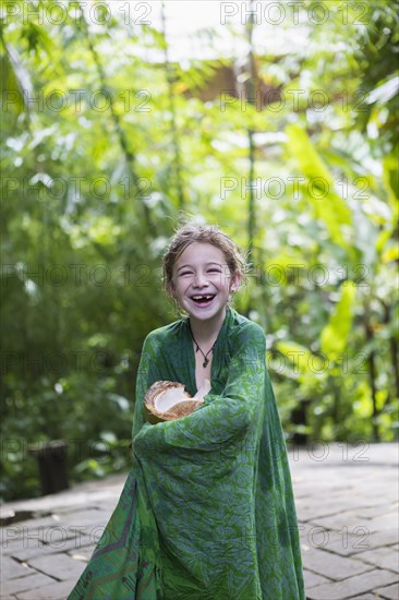 Caucasian girl wrapped in blanket