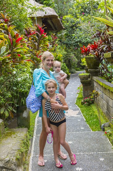 Caucasian family smiling on tropical path