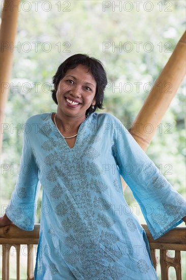 Balinese woman smiling on patio