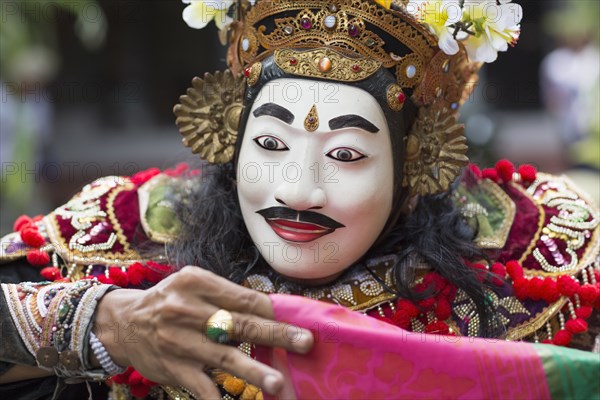 Balinese performer wearing mask and costume