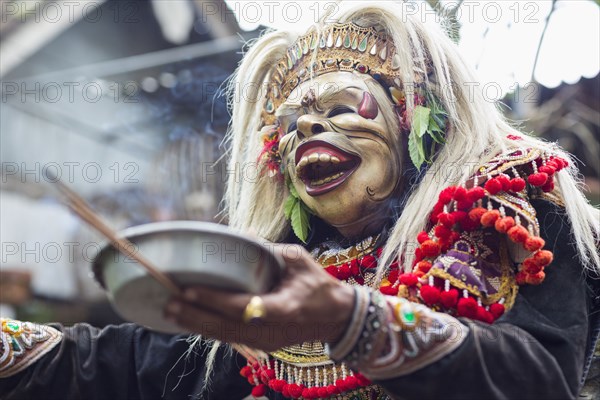 Balinese performer wearing mask and costume