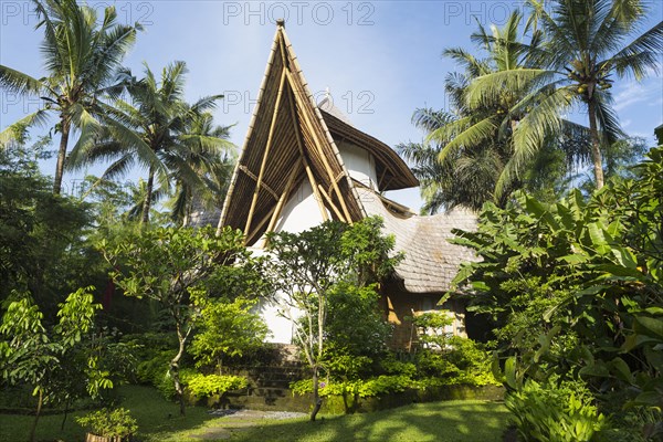 Ornate wood building in tropical landscape
