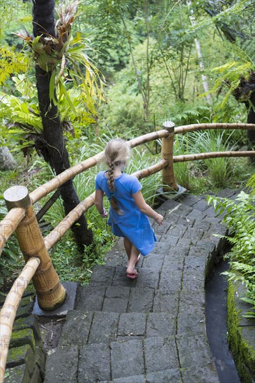 Caucasian girl descending stone steps