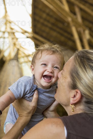 Caucasian mother playing with baby boy