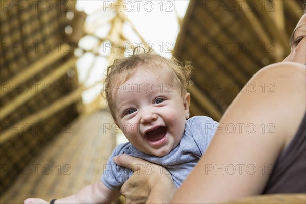 Caucasian mother playing with baby boy
