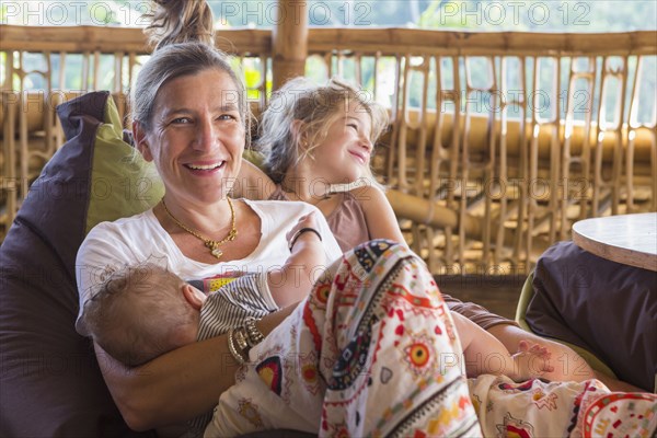 Caucasian mother and children relaxing on patio