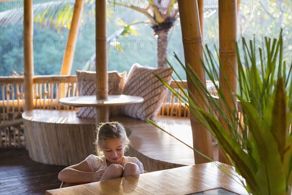 Caucasian girl relaxing on patio