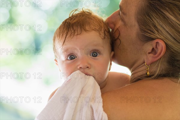 Caucasian mother kissing baby's head