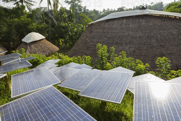 Solar panels among thatched roof buildings