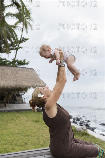 Caucasian mother and baby playing outdoors