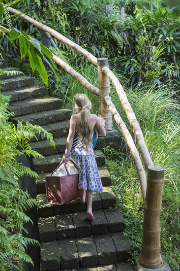 Caucasian girl climbing stone steps