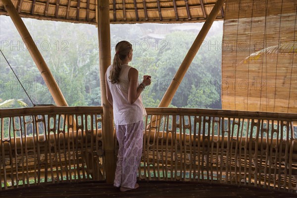 Caucasian woman overlooking view from balcony