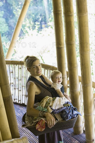 Caucasian mother and baby with basket of laundry