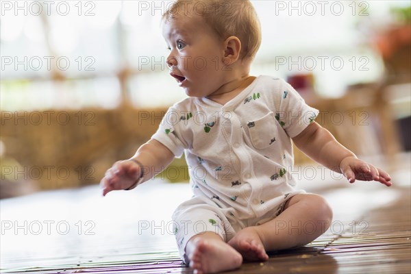 Caucasian baby sitting on floor