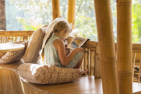 Caucasian girl using digital tablet on patio