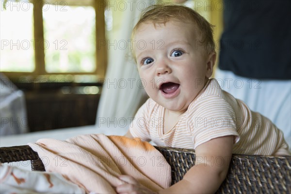 Caucasian baby crawling in bed