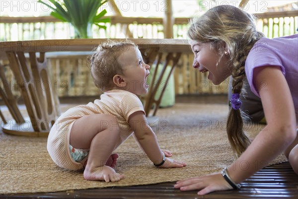 Caucasian children playing on floor