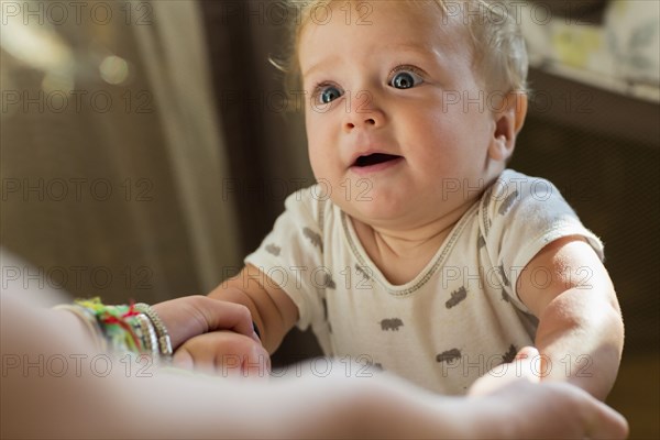 Caucasian baby gasping at mother