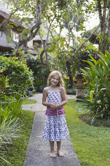 Caucasian girl smiling on stone walkway