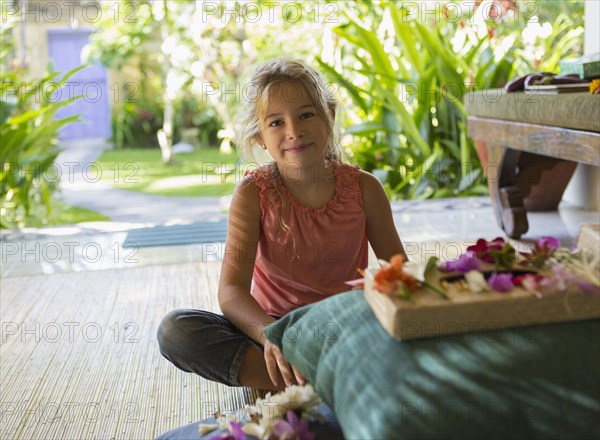 Caucasian girl sitting by shrine