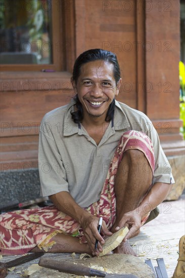 Wood worker smiling and working in studio