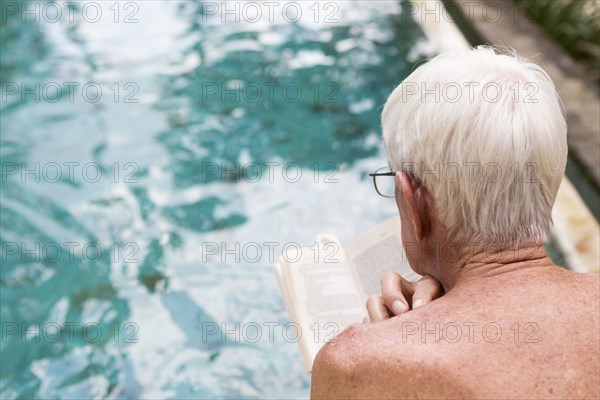 Senior Caucasian man examining swimming pool