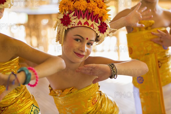 Caucasian girl dancing in traditional Balinese clothing