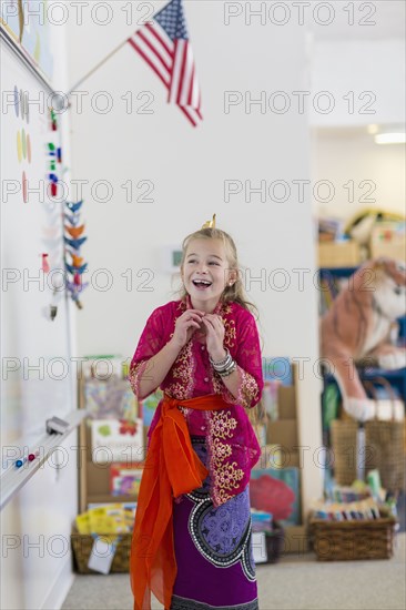 Caucasian girl wearing traditional clothing in classroom