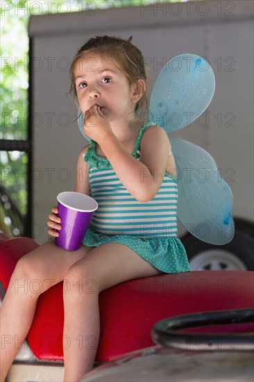 Caucasian girl playing dress up