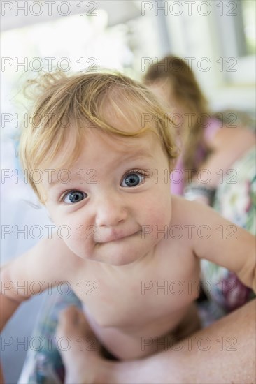 Caucasian baby grimacing