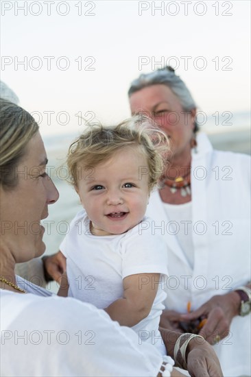 Three generations of Caucasian family on beach