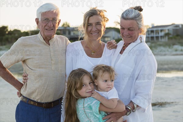 Caucasian family smiling on beach