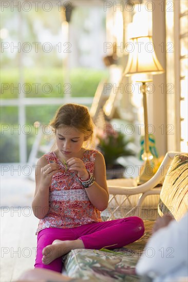 Caucasian girl sitting on patio