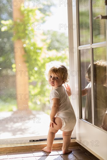 Caucasian toddler standing in doorway