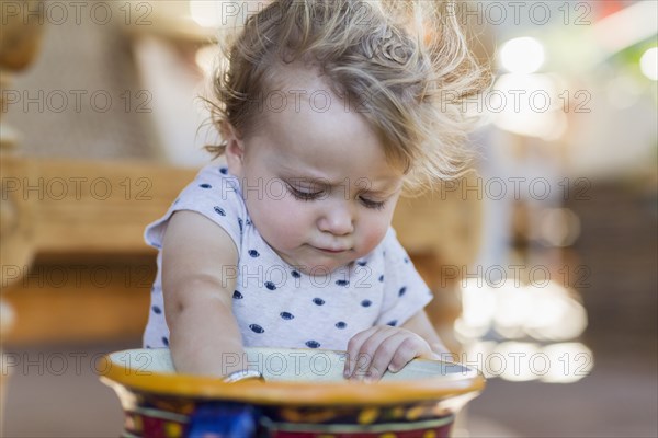 Caucasian toddler digging in bucket