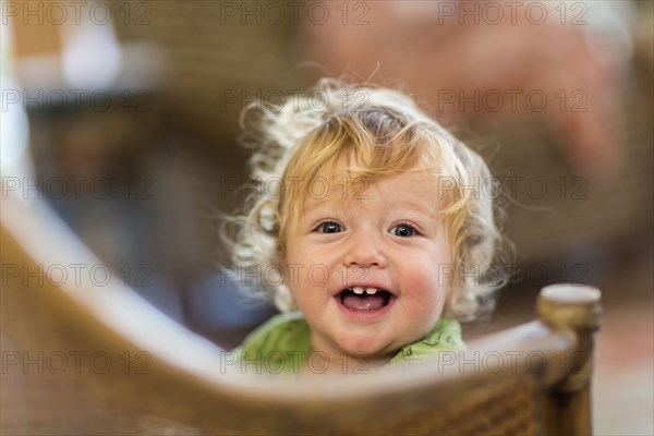 Caucasian toddler standing on chair