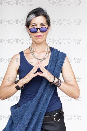 Older Hispanic woman with hands clasped