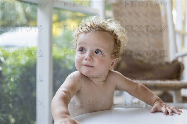 Caucasian toddler standing on porch