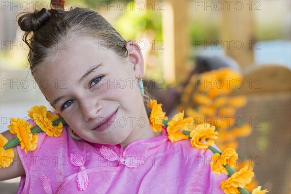 Caucasian girl holding flower chain