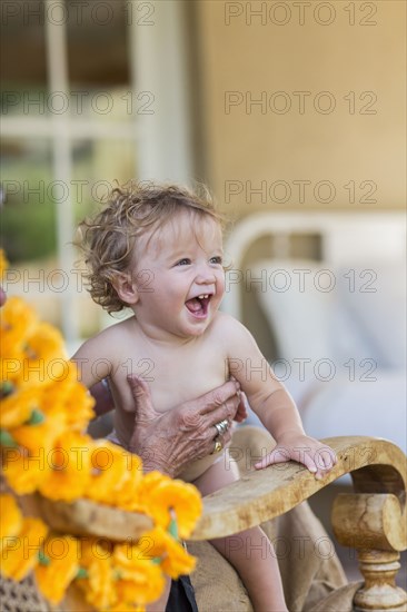 Caucasian boy sitting in lap of grandmother