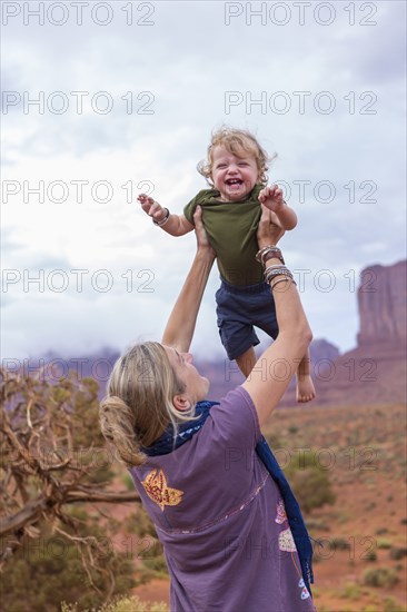 Caucasian mother and son playing in desert