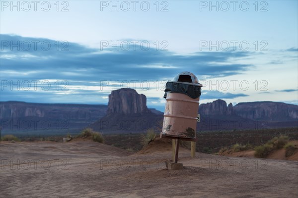 Trash can on stilts in desert