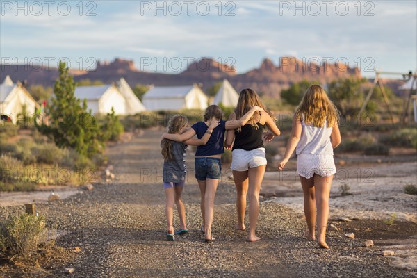 Children walking together on gravel path