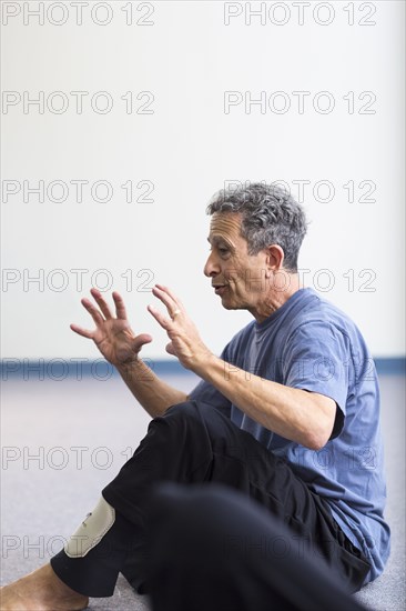 Caucasian teacher gesturing in acting class