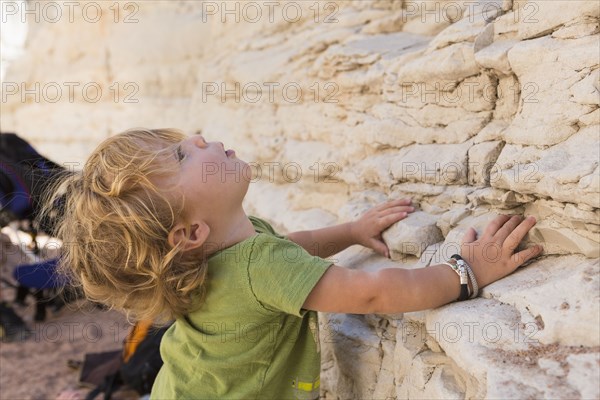 Caucasian baby boy exploring rock formations