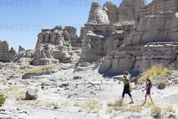 Caucasian mother and children exploring rock formations