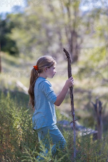 Caucasian girl walking in rural grassy field