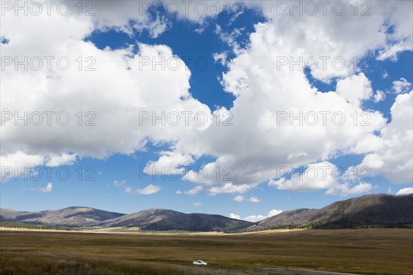 Car driving near mountains in remote landscape